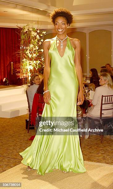 Model wearing a Ralph Lauren lime green satin halter dress