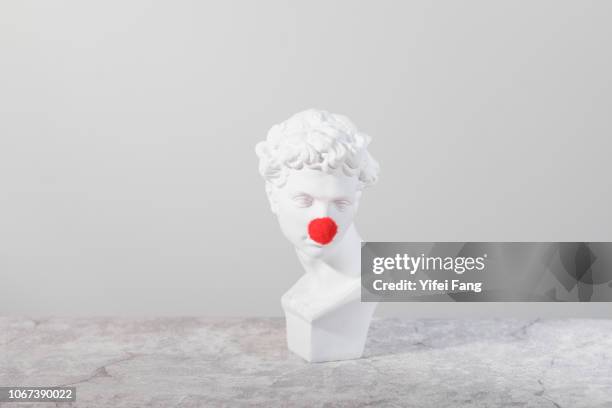 head sculpture with red nose - sculpture bust stock pictures, royalty-free photos & images