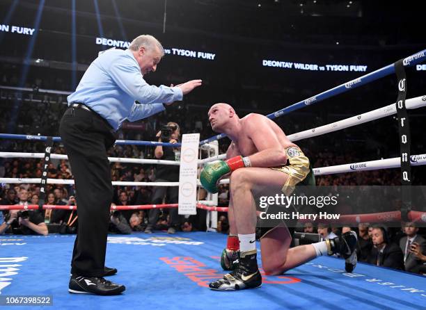 Tyson Fury looks up as he receives a count from referee Jack Reiss in the ninth round fighting to a draw with Deontay Wilder during the WBC...