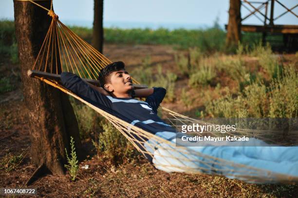 Teenage boy relaxing on hammock