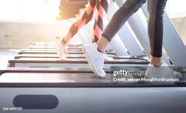 exercise treadmill cardio running workout at fitness gym of woman taking weight loss with machine aerobic for slim and firm healthy in the morning.show of running shoes, rubber floor, softness, - トレッドミル　女性 ストックフォトと画像