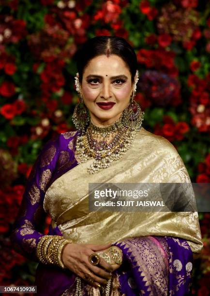 Indian Bollywood actress Rekha poses for a picture during the wedding reception party of actors Ranveer Singh and Deepika Padukone in Mumbai late on...