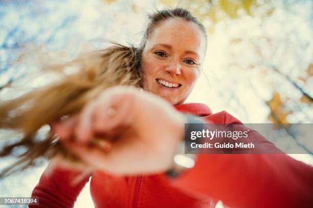 woman checking pulse after jogging. - checking sports fotografías e imágenes de stock