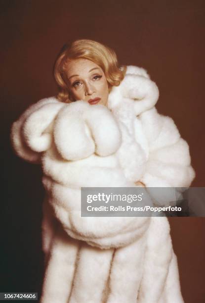 German born American actress Marlene Dietrich pictured wearing a fur coat during a promotional tour for her television special, 'An Evening with...
