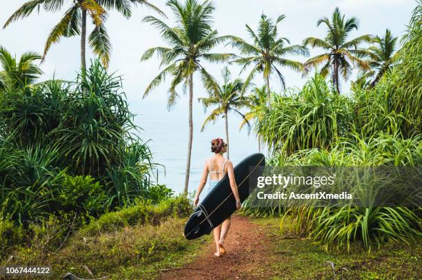 female surfer carries longboard - sri lanka woman stock pictures, royalty-free photos & images