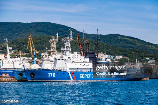 coast guard ship and boat in harbour,kamchatka,russia. - petropavlovsk russia stock-fotos und bilder