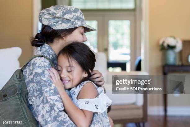 young girl is happy to see army mom - army soldier family stock pictures, royalty-free photos & images