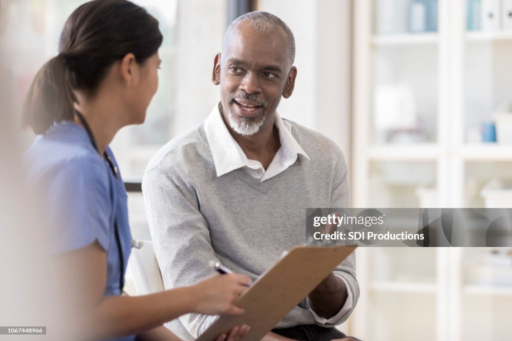 Senior man discusses diagnosis with doctor