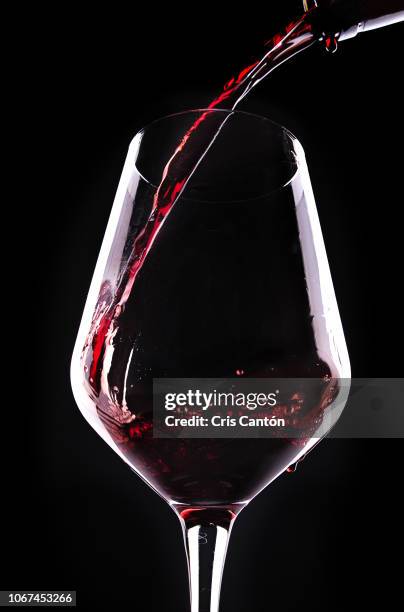 red wine pouring into glass - wine splash stock pictures, royalty-free photos & images