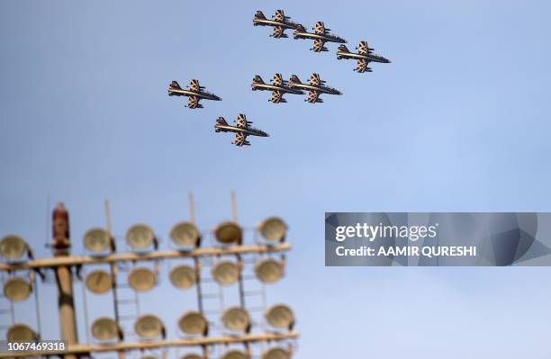 Military aircraft of the United Arab Emirates fly past the Sheikh Zayed International Cricket Stadium in Abu Dhabi on December 2, 2018. - The United...