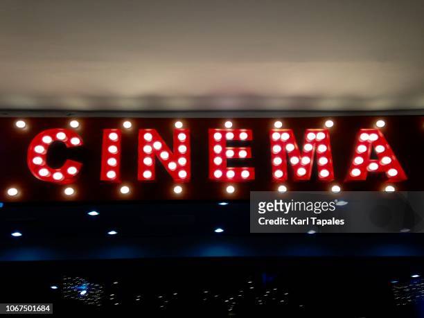 an illuminated single word cinema - prima cinematografica foto e immagini stock