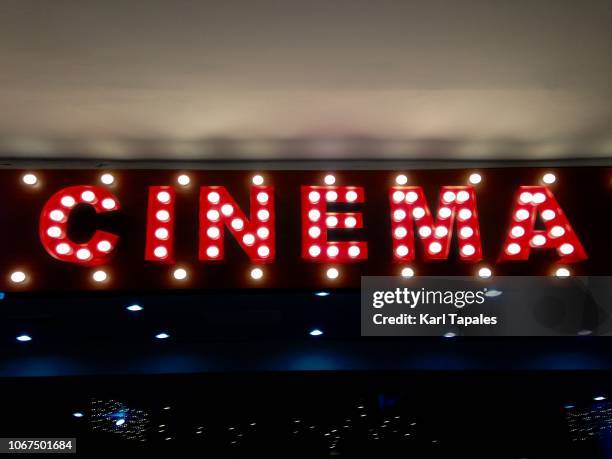 an illuminated single word cinema - empty film set stock pictures, royalty-free photos & images