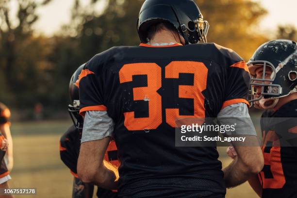 american football players on field - shirt stock pictures, royalty-free photos & images