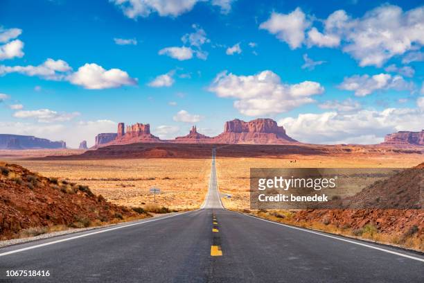 long road at monument valley utah side usa - utah landscape stock pictures, royalty-free photos & images