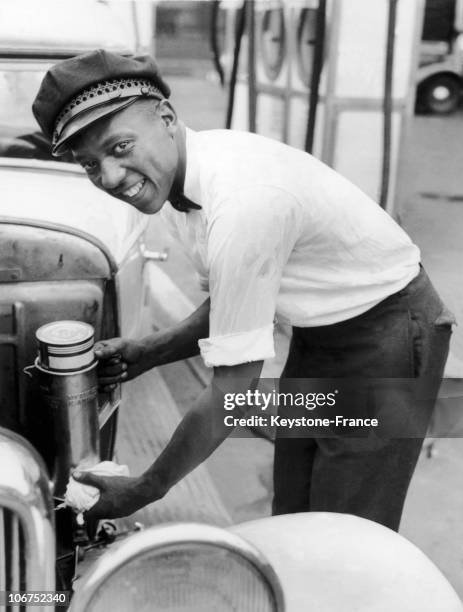 American Sprinter Jesse Owens Pumping Gas At A Gas Station In Cleveland On August 1, 1935. Already A Medalist But Still A Student, The Young Jesse...