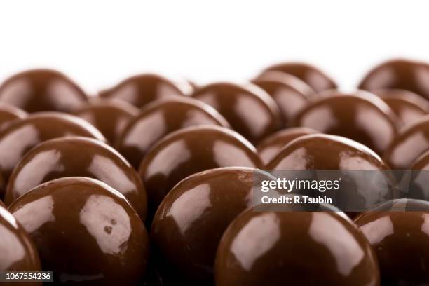 multiple chocolate ball candies composition - pile of candy ストックフォトと画像