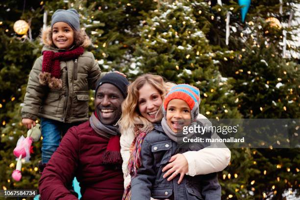 christmas shopping with multi-ethnic family - family snow stock pictures, royalty-free photos & images