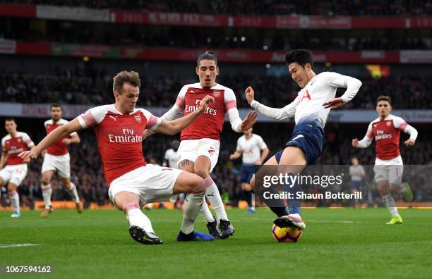 Rob Holding of Arsenal battles for possession with Heung-Min Son of Tottenham Hotspur leading to Tottenham Hotspur's penalty during the Premier...