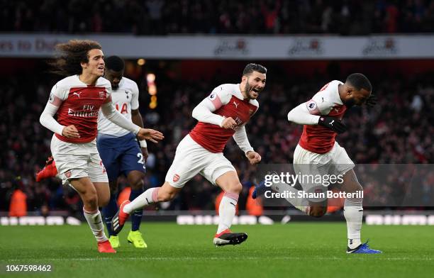 Alexandre Lacazette of Arsenal celebrates with teammates after scoring his team's third goal during the Premier League match between Arsenal FC and...