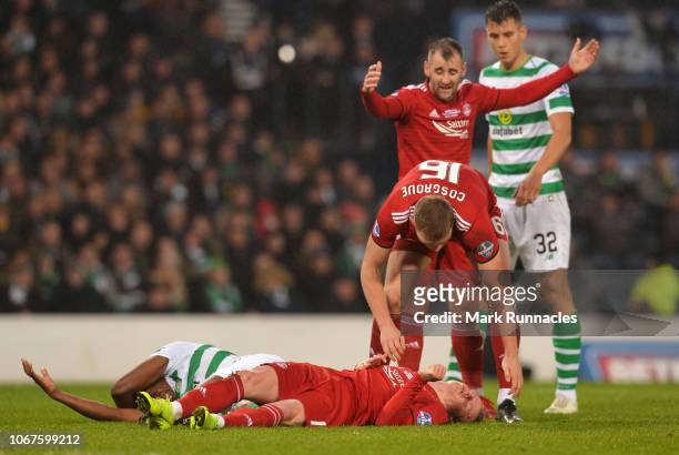 Sam Cosgrove of Aberdeen stands over injured team mate Gary Mackay-Steven of Aberdeen as he clashes heads with Dedryck Boyata of Celtic during the...