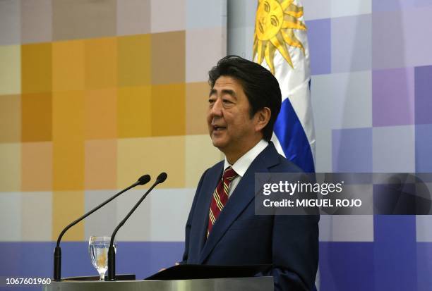 Japan's Prime Minister Shinzo Abe speaks next to Uruguay's President Tabare Vazquez during a press conference following a meeting at the presidential...