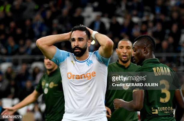 Marseille's French defender Adil Rami reacts after failing to score during the French L1 football match between Olympique de Marseille and Reims at...