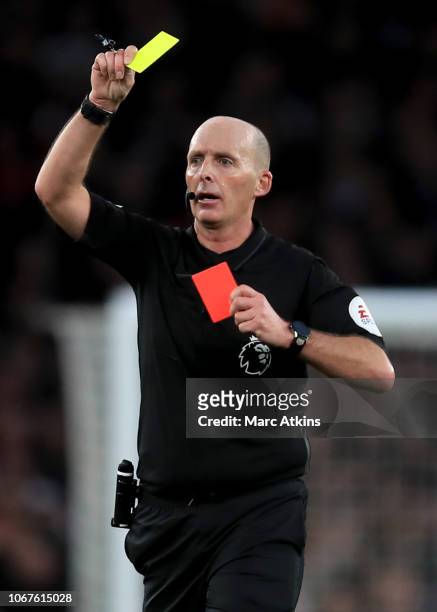 Referee Mike Dean shows a 2nd yellow followed by a red card during the Premier League match between Arsenal FC and Tottenham Hotspur at Emirates...