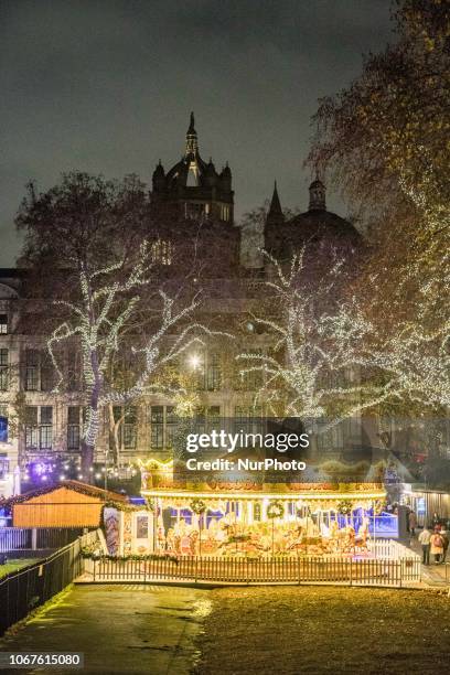 Christmas time decoration in London. Evening outside of the Natural History Museum of London with Christmas decoration, a carousel, an Ice Rink and a...