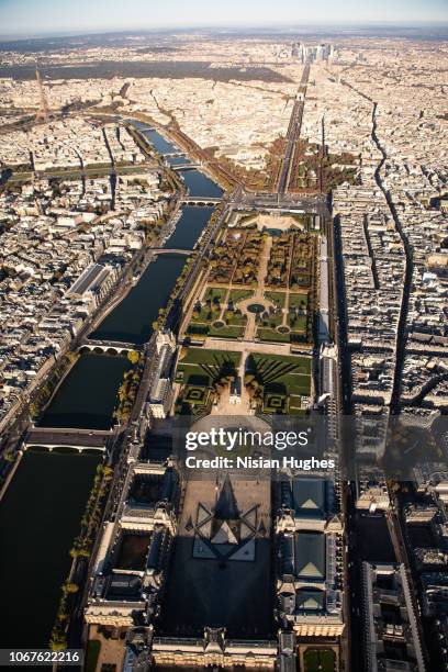 aerial flying over musée du louvre in paris france, daytime - place du louvre stock pictures, royalty-free photos & images