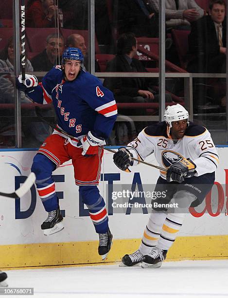 Michael Grier of the Buffalo Sabres holds up Michael Del Zotto of the New York Rangers at Madison Square Garden on November 11, 2010 in New York City.