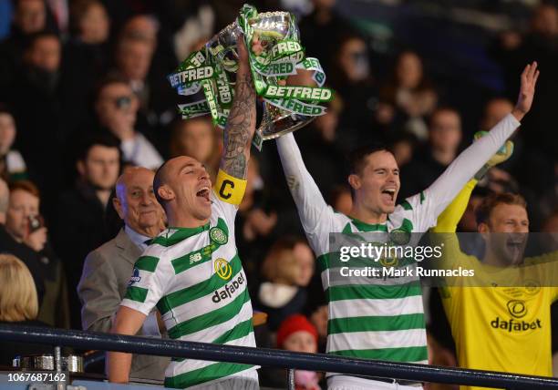 Scott Brown , and Mikael Lustig of Celtic lift the League Cup Trophy during the Betfred Cup Final between Celtic and Aberdeen at Hampden Park on...