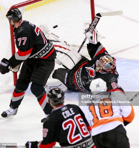 The Philadelphia Flyers' Mike Richards puts the puck past the Carolina Hurricanes' Joe Corvo , Erik Cole and goalie Justin Peters for a third-period...