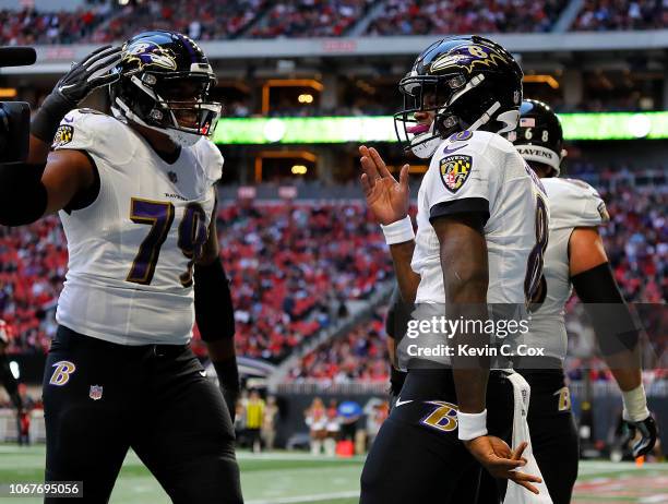 Lamar Jackson of the Baltimore Ravens celebrates rushing for a touchdown against the Atlanta Falcons at Mercedes-Benz Stadium on December 2, 2018 in...