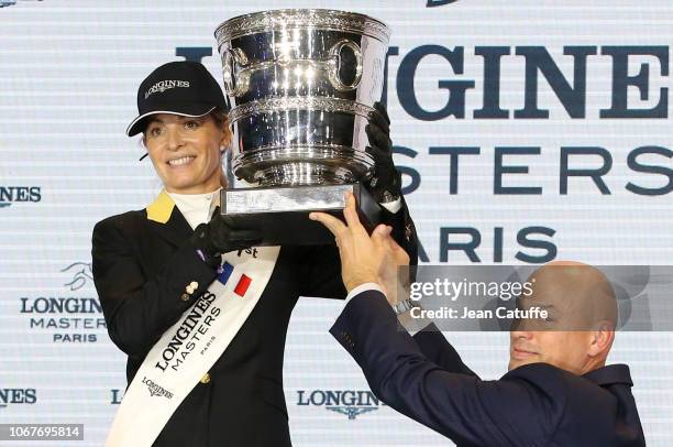 Winner Edwina Tops-Alexander of Australia, Director of Longines France Frederic Bondoux during the trophy ceremony of the Longines Grand Prix 2018, a...