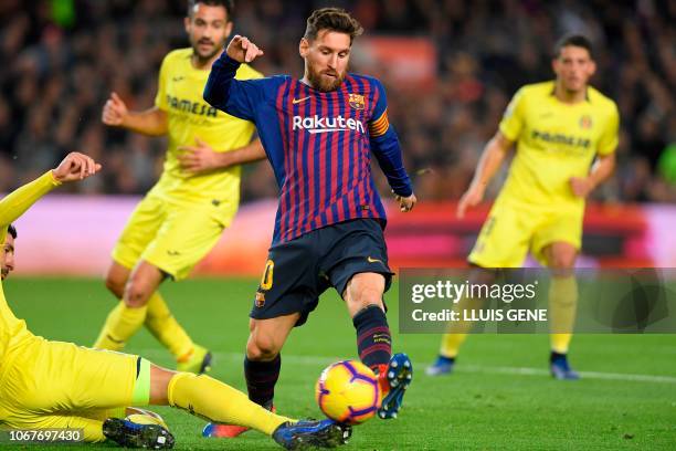 Barcelona's Argentinian forward Lionel Messi vies with Villarreal's Spanish defender Alvaro Gonzalez during the Spanish league football match FC...