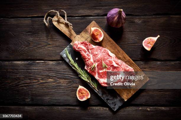 raw steak on cutting board ready to cook - pork cuts stock pictures, royalty-free photos & images