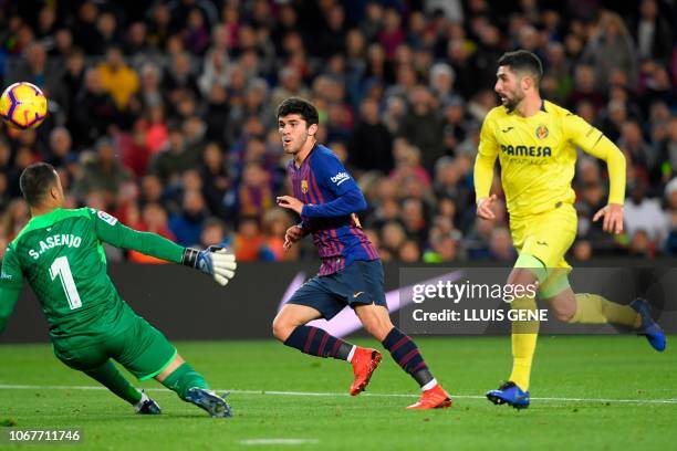 Barcelona's Spanish midfielder Carles Alena scores against Villarreal's Spanish goalkeeper Sergio during the Spanish league football match FC...