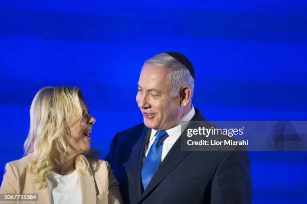 Israeli Prime Minister Benjamin Netanyahu stands by his wife Sara before lighting a stylised-menorah during the start of Hanukkah, the Jewish...