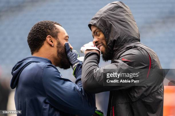 Richard Sherman of the San Francisco 49ers talks with Doug Baldwin of the Seattle Seahawks during pre-game warmups at CenturyLink Field on December...