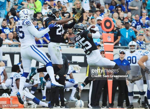 Hayden of the Jacksonville Jaguars leaps for the football in front of Eric Ebron of the Indianapolis Colts during their game at TIAA Bank Field on...
