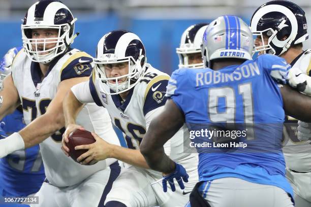 Quarterback Jared Goff of the Los Angeles Rams looks to run the ball against A'Shawn Robinson of the Detroit Lions during the second half at Ford...