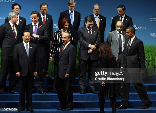 President Barack Obama, bottom right, arrives while Hu Jintao, China's president, bottom left, stands during a photo session at the G-20 Seoul Summit...