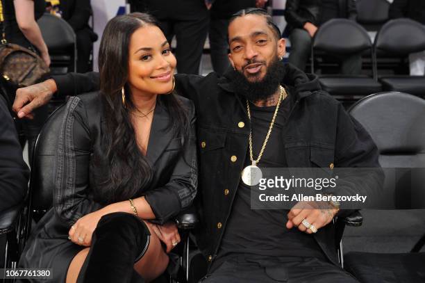 Nipsey Hussle and Lauren London attend a basketball game between the Los Angeles Lakers and the Portland Trail Blazers at Staples Center on November...