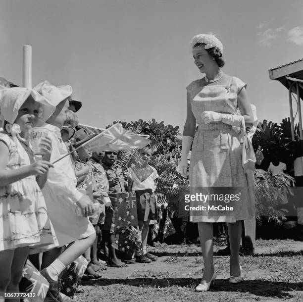 Elizabeth II, Queen of the United Kingdom, meeting children as she visits Australia on a Royal Tour, 18th April 1963.