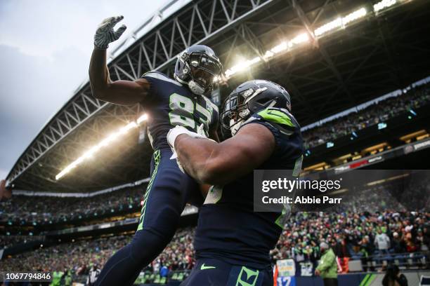 Rashaad Penny of the Seattle Seahawks celebrates his touchdown with teammate David Moore in the third quarter against the San Francisco 49ers at...