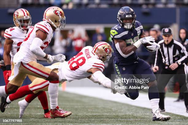 Chris Carson of the Seattle Seahawks runs the ball passed Fred Warner of the San Francisco 49ers in the third quarter at CenturyLink Field on...