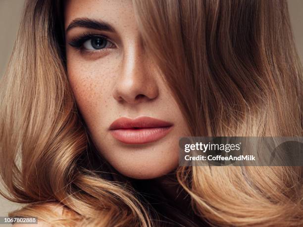 young beautiful model with long wavy well groomed hair - shiny wavy hair stock pictures, royalty-free photos & images