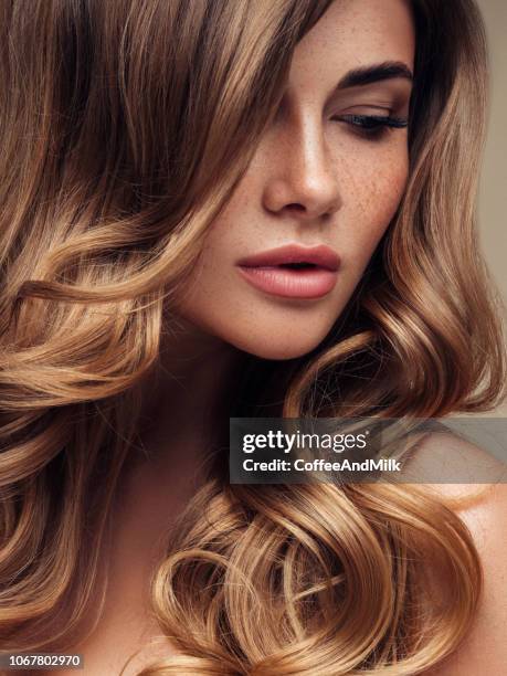 young beautiful model with long wavy well groomed hair - shiny skin stock pictures, royalty-free photos & images