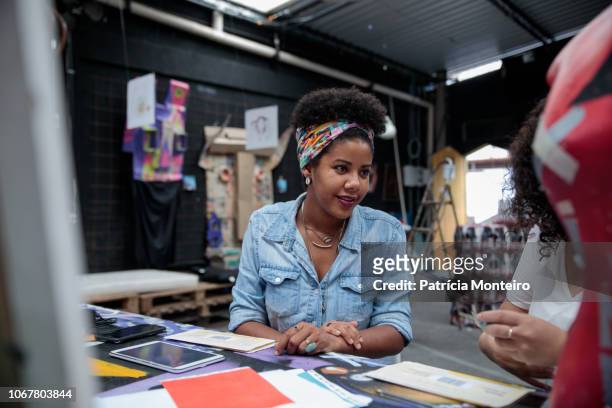 Woman talks to a colleague at an art center in Rio de Janeiro
