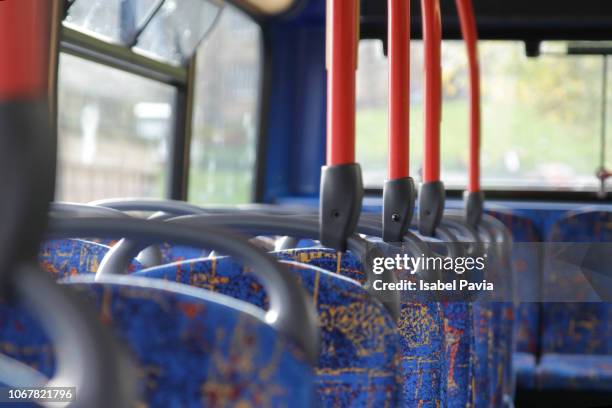 cropped shot of empty seats on a public bus - bus interior fotografías e imágenes de stock